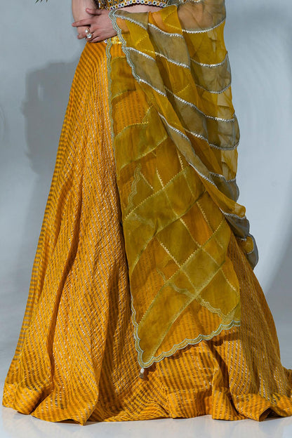 Yellow tissue silk lehenga with mirror work