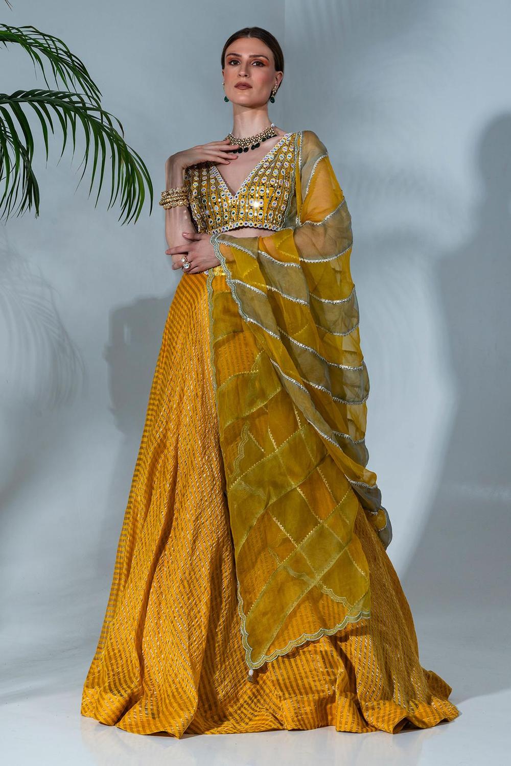 Yellow tissue silk lehenga with mirror work